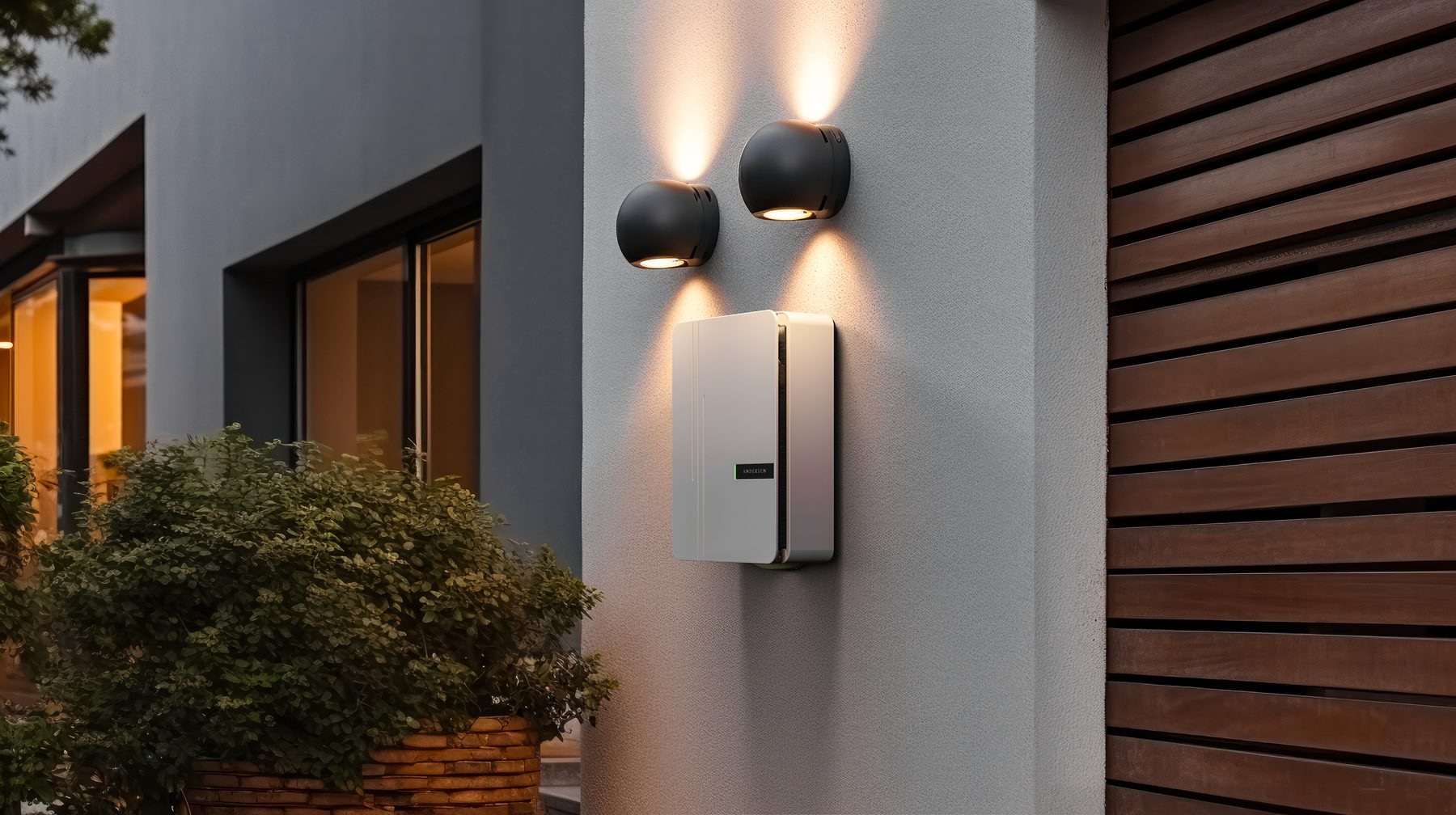 Andersen EV charger in white, mounted on a rendered wall beneath outdoor wall lights